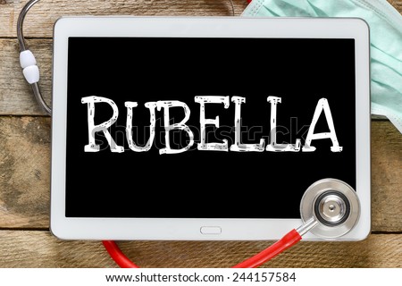 Tablet pc with word Rubella. Tablet pc with word Rubella and stethoscope, medicine concept