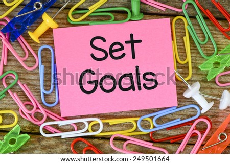Set goals inscription on sticker. Set goals inscription on sticker, at the background with paper clips