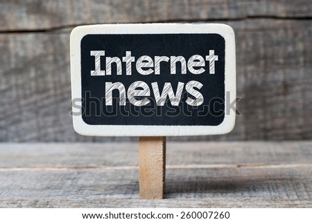 Internet news on blackboard. Internet news handwritten on framed blackboard