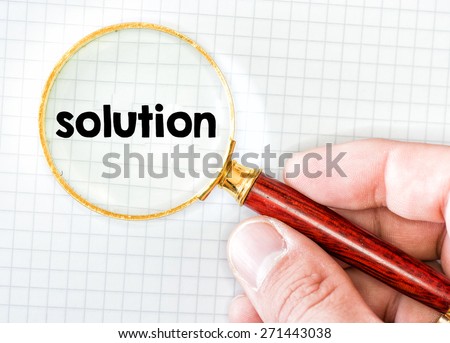 Hand with magnifying glass and solution. Hand holding classic styled magnifying glass, with solution word.