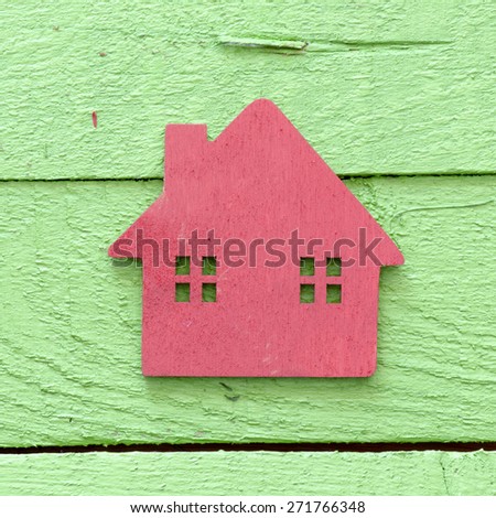 Red Toy wooden house on wooden background