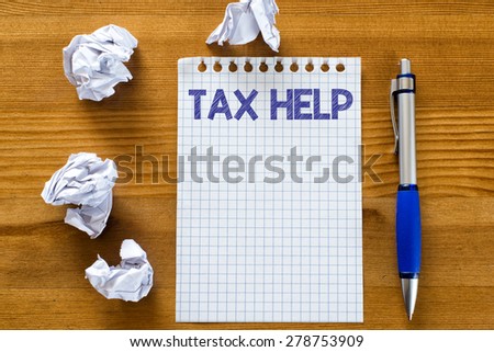 Blank note paper with tax help. Blank note paper with tax help and pen on wood background