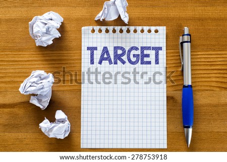 Blank note paper with target. Blank note paper with target and pen on wood background