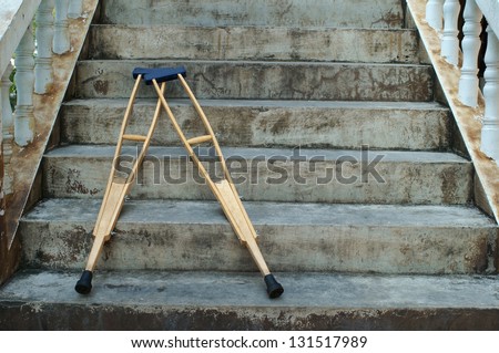 crutches lay down on stair.