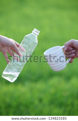 hand giving drinking water.