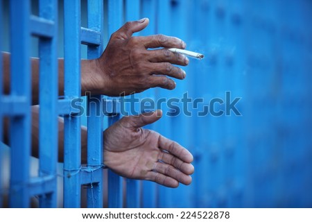 hand keeping cigarette in jail