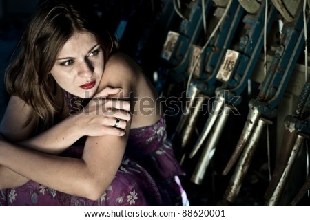 Frightened woman in a scary room