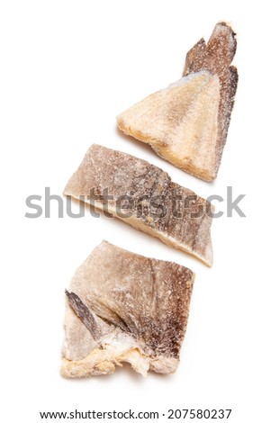 Pieces of salt cod fish isolated on a white studio background.