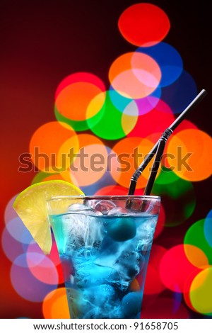 Blue Hawaiian cocktail on bokeh background