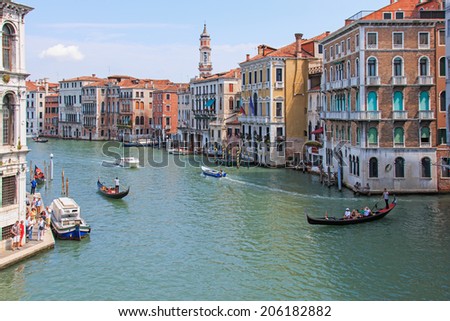 Venice, Italy - June 28, 2014:  People enjoying a tour of the beautiful surroundings of the Grand Canal.