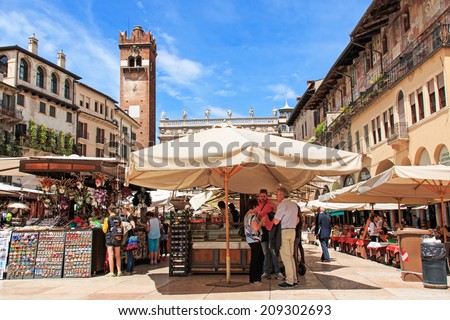 Verona, Italy - May 16, 2014: tourists and Veronese people in Piazza delle Erbe, the oldest square in Verona. In the fourteenth century, this place was the the heart of the city.