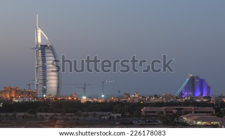 Dubai, United Arab Emirates - October 8, 2014: A night shot of Dubai\'s most well known landmarks : The Burj Al Arab and Jumeraih Beach Hotel.