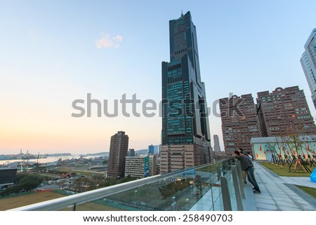 Kaohsiung, Taiwan - February 26,2015: People next to the Tuntex Sky Tower watching the Sunset . The structure is 378 m high.