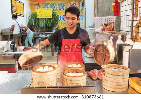 Kaohsiung, Taiwan - August 9,2015: Street food vendor in Kaohsiung, Taiwan, preparing the steamed Xiao Long Bao, a traditional chinese dish invented in Shanghai