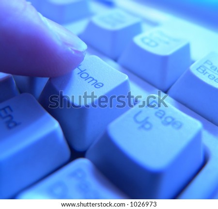 Hand pressing the home button on a computer keyboard