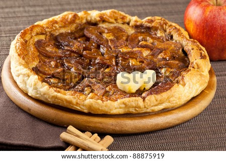 Apple pie with two romantic heart, cinnamon sticks and apple