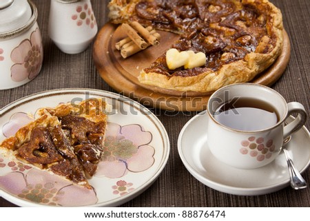 cup of tea or coffee and a romantic heart shaped and sliced apple pie