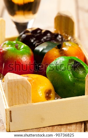 wood box of sweet traditional marzipan fruit and glass of dessert wine