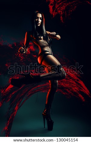 bdsm woman with whip in lava