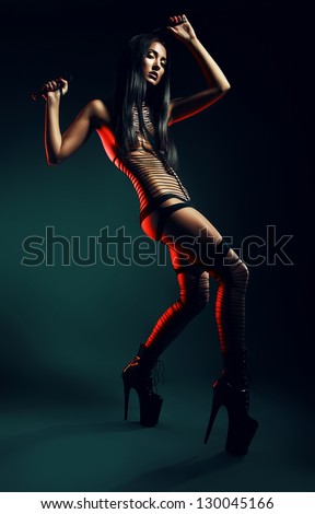 woman on high heels with whip above head