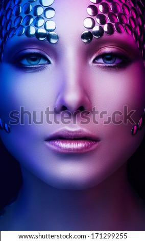 woman with metal buttons on face