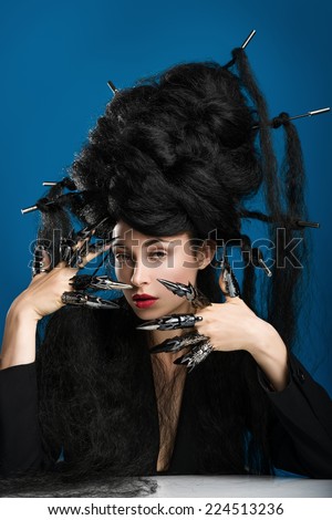 Woman with crazy hair on a blue background