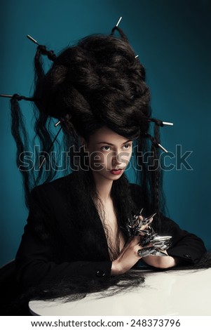 girl with fluffy hair sitting at the table