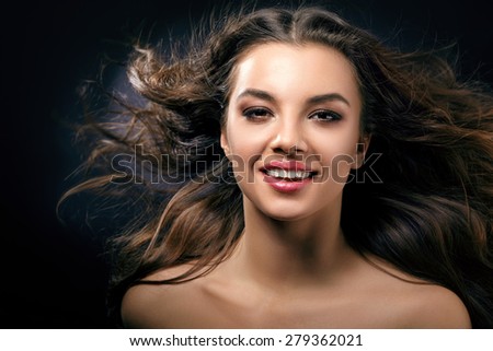 A smiling woman with flowing hair close-up