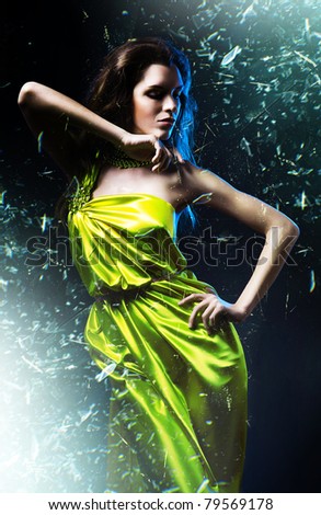 slim sexy woman in green dress and shuttered glass
