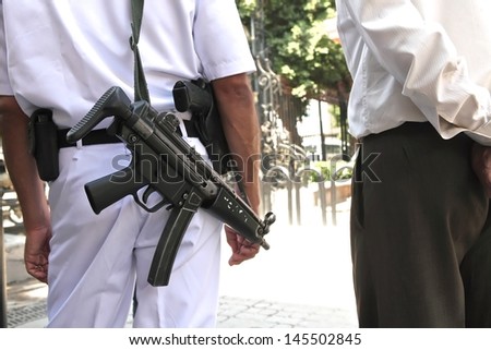 CAIRO, EGYPT-JUN 15: A tourist police with submachine guns guards at the entrance of Egyptian Museum on June 15, 2011. The museum was invaded during Egyptian revolution on Jan 2011. Cairo.
