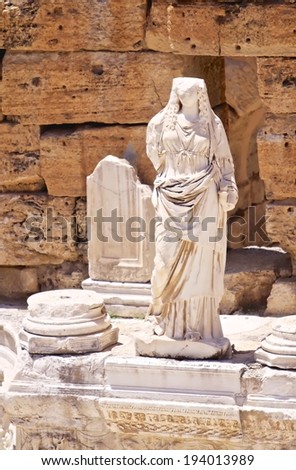 PAMUKKALE, TURKEY -JULY 1: Ruins statue in the ancient theater of the Roman city of Hierapolis on July 1, 2009 in Pamukkale, Turkey. The site is a UNESCO World Heritage site.