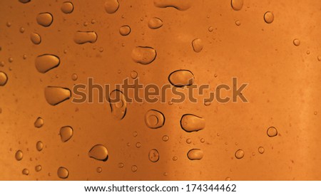 Fresh background of water drops on orange surface