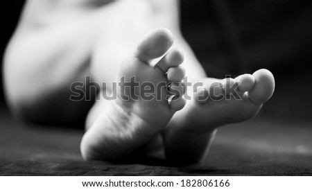 Black and white woman legs and feet with dark background