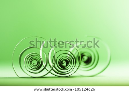Macro, abstract, background picture of green paper spirals on paper background