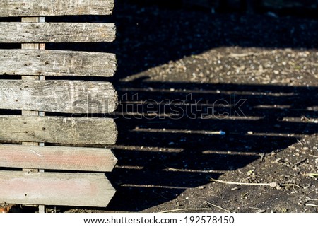Wooden texture from a fence with soil texture and shadows