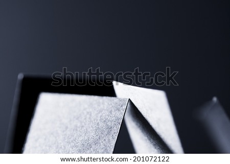 Black paper shapes and shadows with black paper background
