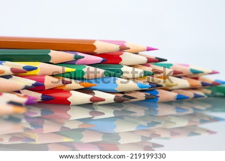 Group of sharp colored pencils with white background and reflexions