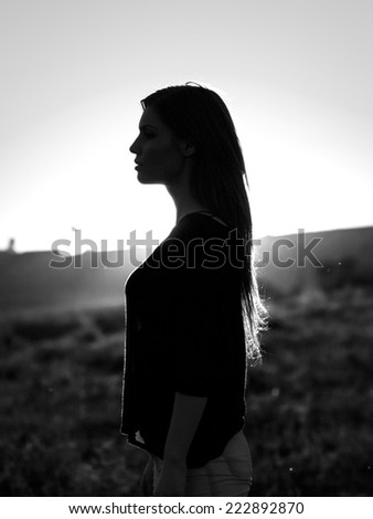 Woman silhouette in the sunset light. Black and white, artistic photography