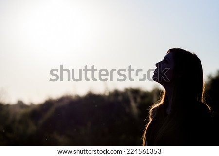 Woman silhouette in the sunset light. Artistic photography