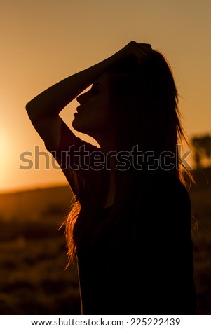 Woman silhouette in the sunset light. Artistic photography