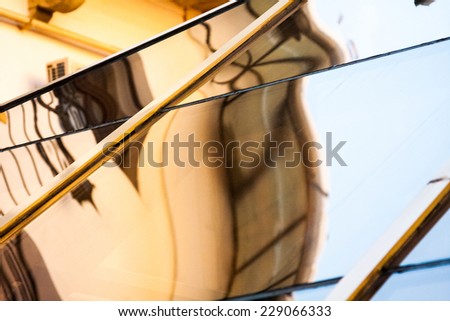 Abstract composition with glass and architecture details reflected and distorted. Image has grain texture visible on maximum size
