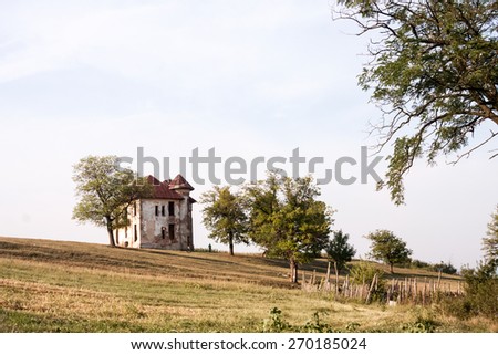 Old, abandoned, ruined house in the field