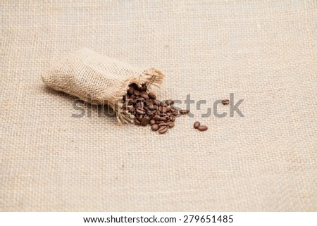 Coffee beans and small bag with burlap texture