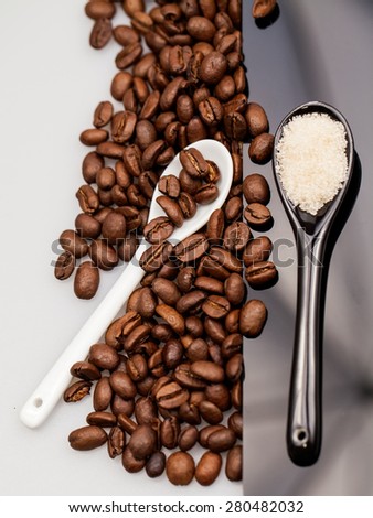 Coffee beans, brown sugar and small teaspoons
