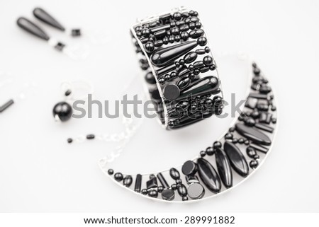Silver jewels with onyx stones and light grey background