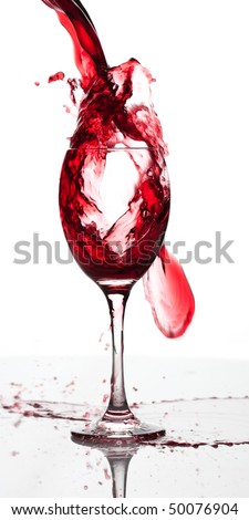 Red wine pouring down into a wine glass isolated on white backgroun
