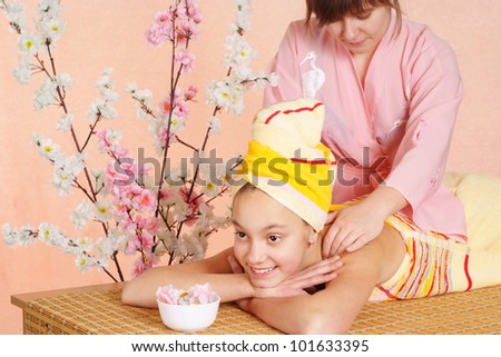 the girl lies on a table in the spa salon
