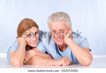 portrait of an aged couple lying at floor