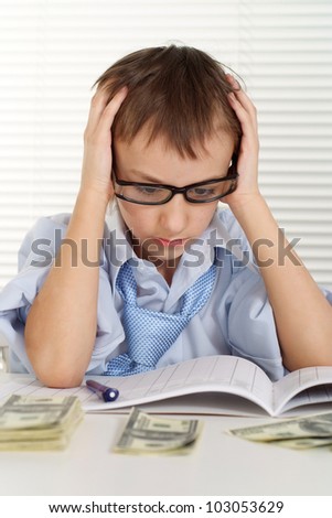 Caucasian young lad sits on a business magazine and thinks on a white background