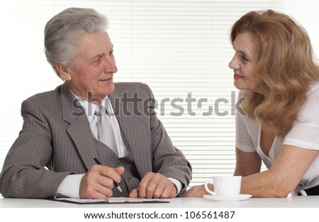 Happy elderly man with a lady on a light background